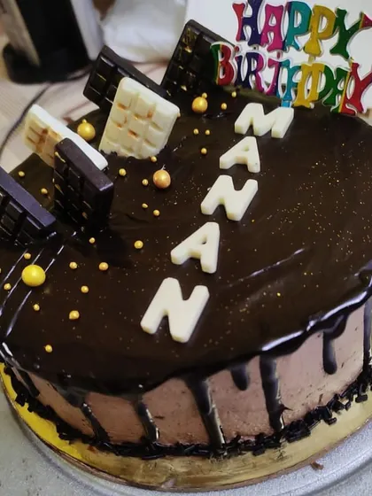 A personalized chocolate drip cake for Manan's birthday. This one is loaded with a mix of dark and white chocolate bars on top of a rich chocolate ganache.