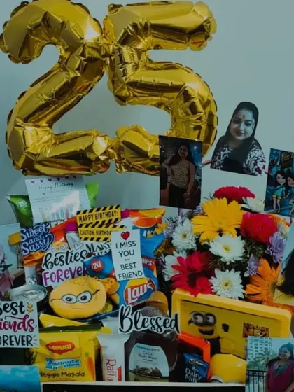 A 25th birthday hamper designed for a best friend. This gift includes fresh flowers, snacks, a minion-themed item, and personal photos, all tied together with a '25' foil balloon to mark the quarter-century celebration.