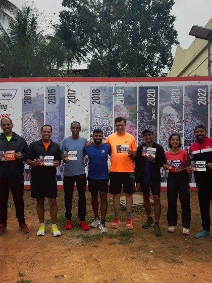 The Road to Trail Club team is all set for the Bengaluru 10k Challenge, holding up our race bibs.