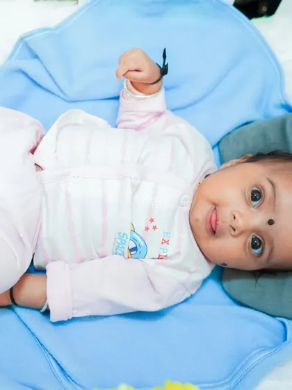A sweet, alert moment from a newborn during her naming ceremony photoshoot. Even at just a few days old, their little personalities start to shine.