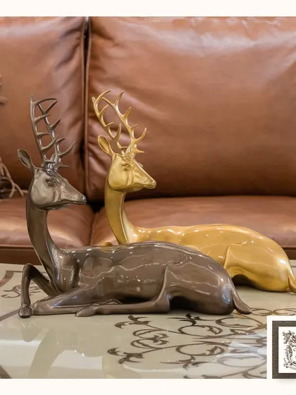 This duo of deer sculptures, one in a bronze finish and the other in gold, brings a sense of graceful grandeur to any tabletop. They are a statement of timeless elegance, perfect for a coffee table or console.