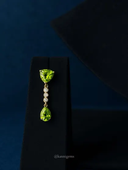 The matching peridot and diamond drop earring, designed to perfectly complement the necklace while being elegant enough to wear on its own.