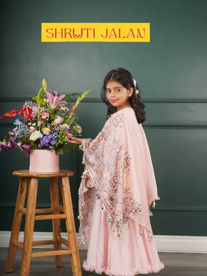 Another look at the sister cape gowns in pink and blue. These outfits are designed to be as magical as their bond.