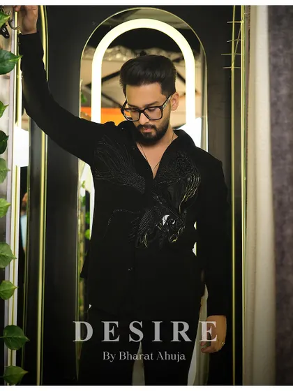 A pensive pose in the black-on-black embroidered shirt. It's a look that is both charming and full of edge.