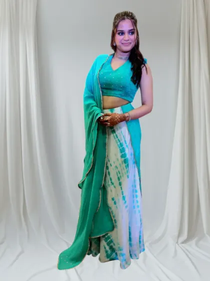 It brings me so much joy to see my clients happy in their custom outfits. I designed this vibrant tie-dye skirt and mirror-work halter blouse for a sangeet celebration. The outfit was crafted to be as full of life and personality as she is, perfect for dancing the night away.