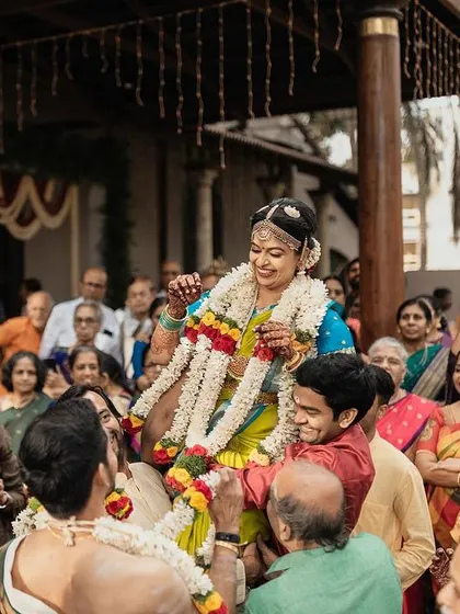 A joyous moment from a traditional Brahmin wedding ceremony. The bride's makeup is designed to be radiant and picture-perfect, even in candid shots.