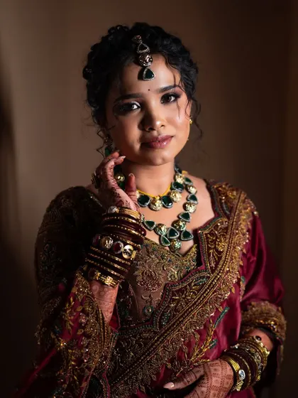 Lavanya looking serene and beautiful. The soft lighting highlights the intricate details of her jewelry and the flawless finish of her makeup.
