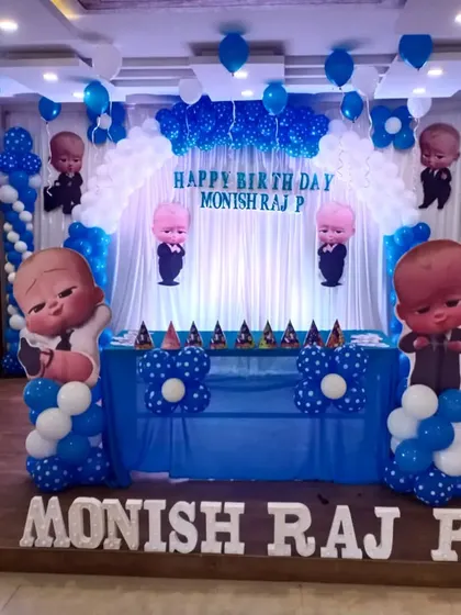 A complete Boss Baby themed decoration for Monish Raj P. This setup includes a custom backdrop, multiple character cutouts, and a balloon arch over the main table, perfect for a fun celebration.