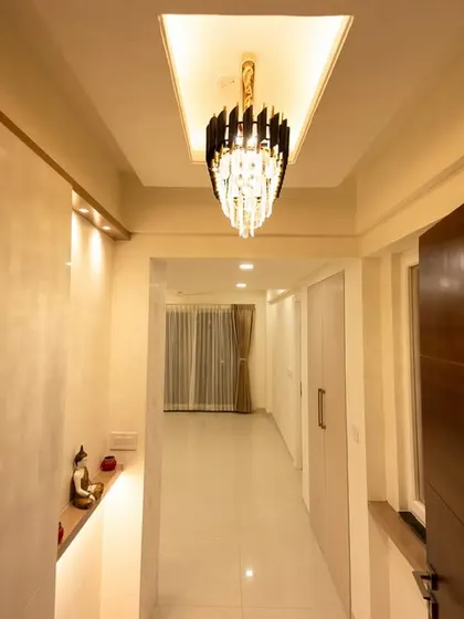 The elegant hallway in Bhavinee's home, featuring a stunning crystal chandelier that adds a touch of glamour and sophistication to the entryway.