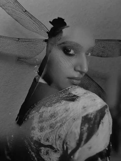 A black and white double exposure portrait created for the brand Ruhr India. This artistic technique merges a model's profile with the delicate wings of a dragonfly, resulting in a moody and ethereal image.