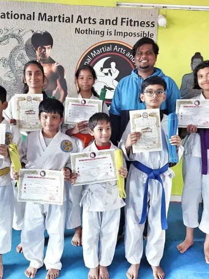 The full group of newly promoted students, showcasing a wide range of new belt ranks.