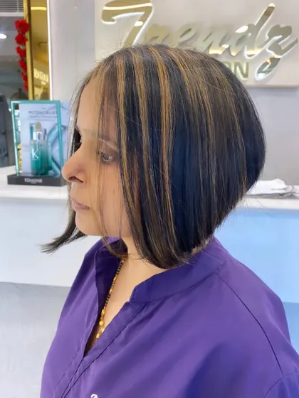 The clean lines and expert layering of this bob haircut are evident from this side profile. A timeless yet modern choice.