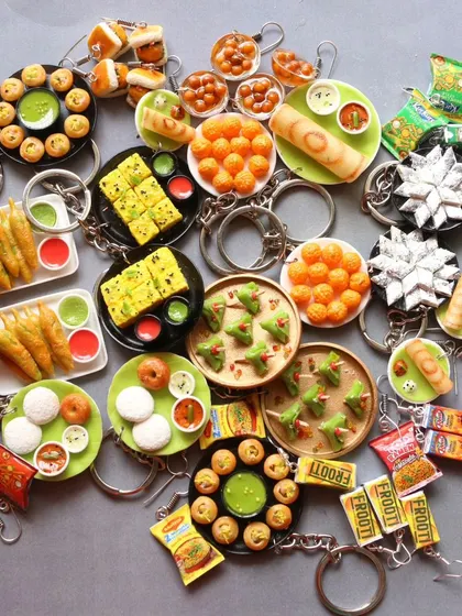 A huge collection of my recent keychain orders, featuring a wide variety of Indian dishes.