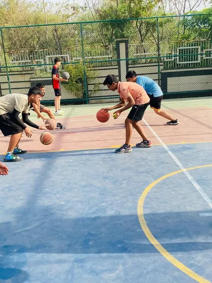 Fundamentals are everything. Here, our players are locked in on a ball-handling drill, improving their control and coordination. Mastering these basics is key to becoming a versatile player.