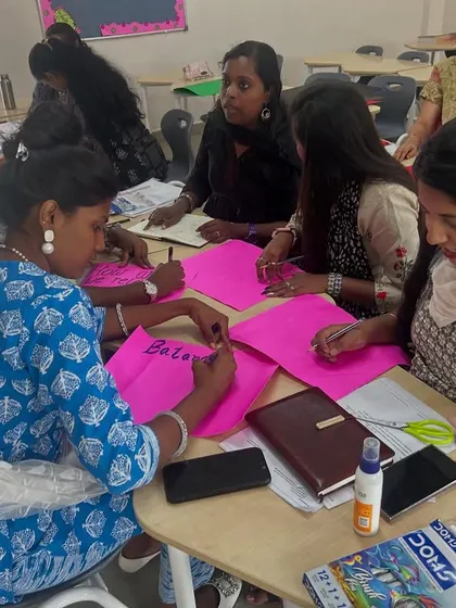 Teachers at Cambridge School work together on a hands-on activity using colorful paper. This exercise is part of the 'Math From Scratch' program, designed to build a strong foundation in early math education.