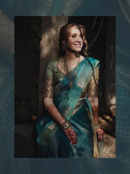 A beautiful portrait of a bride in a traditional saree, seated in the soft sunlight. The natural setting enhances the elegance of her attire.