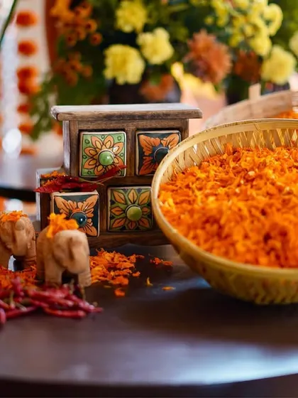 The smallest details matter. We set up this table with baskets of fresh marigold petals, tiny elephant figurines, and a hand-painted spice box, celebrating the rituals and aesthetics of the ceremony.