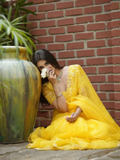 A playful shot of the yellow saree, capturing its cheerful and elegant vibe.