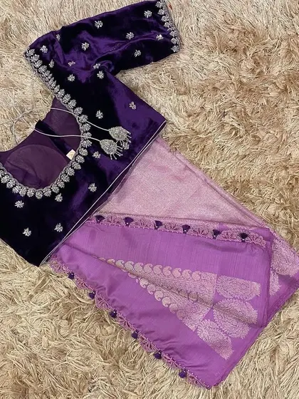 A luxurious velvet violet blouse with silver hand embroidery, paired with a lavender silk saree. The contrast in textures is beautiful.