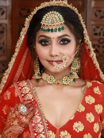 A classic bridal pose showcasing the flawless makeup. The sharp winged eyeliner and perfectly blended eyeshadow are key features of this signature bridal look.