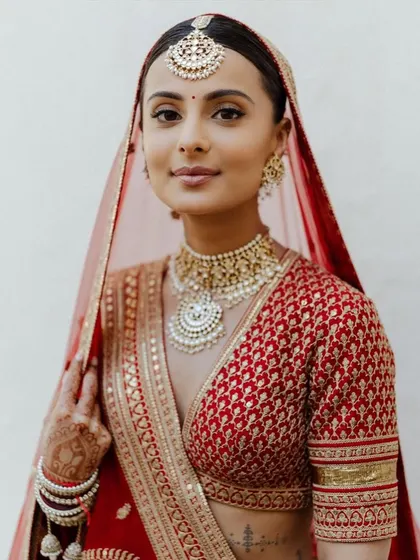 A classic red bridal look will never go out of style. For this bride, I created a soft glam look with defined eyes and a neutral lip, ensuring her natural beauty was the focus. This timeless makeup is perfect for the main wedding ceremony.