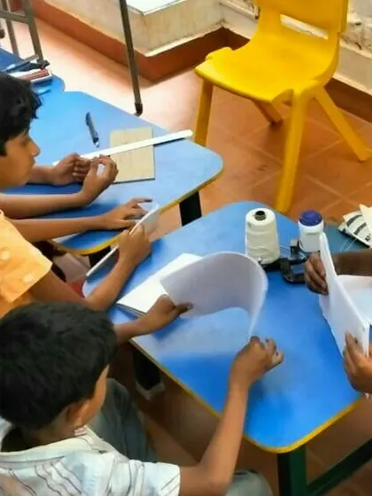 Another view of the kids' bookbinding session. We provide all the materials, from paper to thread, to help them create their own unique notebooks.
