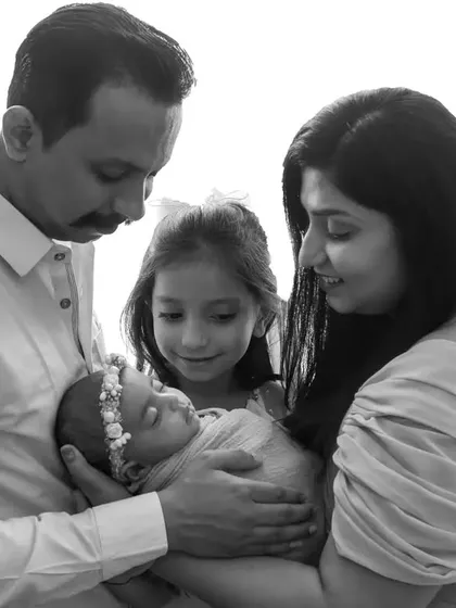 A beautiful family moment with an older sibling, made even more touching in classic black and white.