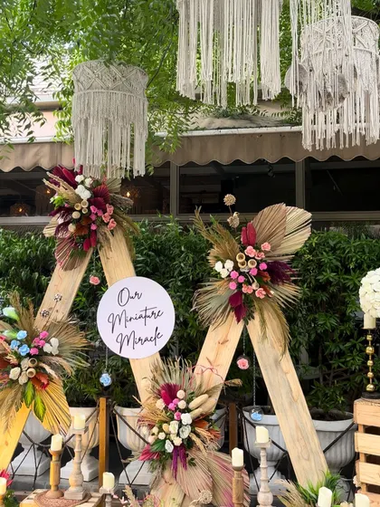 A wider view of the "Miniature Miracle" backdrop, showing the hanging macrame chandeliers that add to the bohemian vibe.