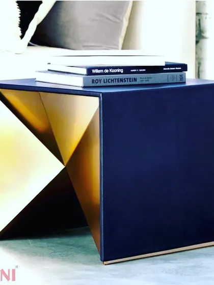 This bedside table is a perfect example of modern, geometric design. The deep blue exterior contrasts sharply with the metallic gold interior, creating a striking visual effect. It's a small piece that delivers a big impact.