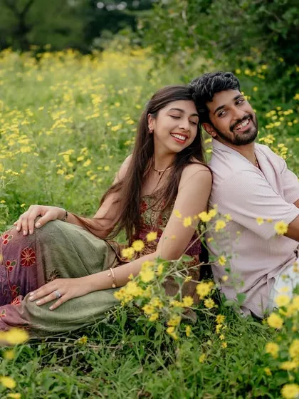 Another angle of their relaxed pose in the field. The yellow flowers add a beautiful pop of color to this romantic nature photoshoot.