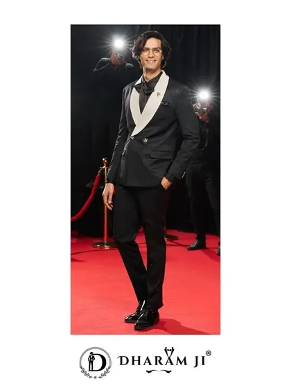 This black double-breasted tuxedo with a contrasting white lapel is a modern classic. It's perfect for a black-tie wedding or a high-fashion event.