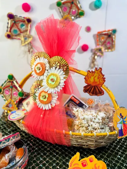 Gift a bundle of warmth and happiness this Lohri with our festive basket hamper. It's decorated with kites and bonfire motifs and filled with popcorn and other traditional munchies.