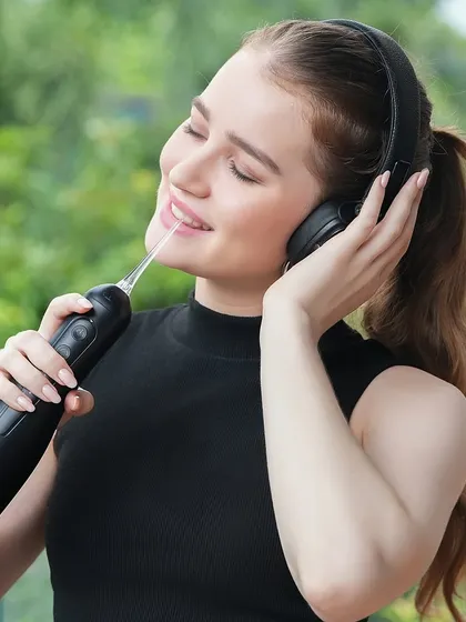 The model enjoys the music while using the product, creating a sensory experience that enhances the product's appeal.