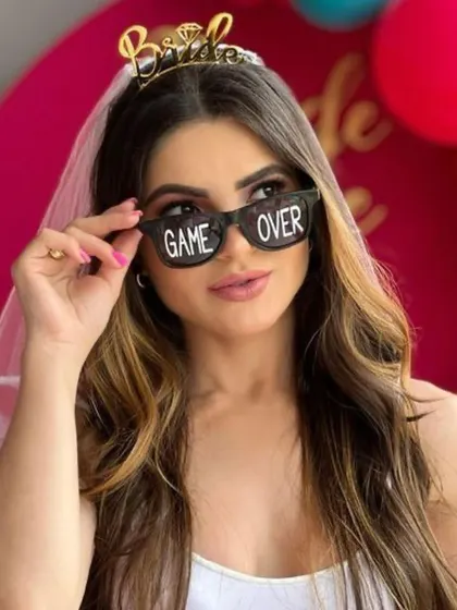 Game over! These fun sunglasses are the perfect prop for a bachelorette party photoshoot, adding a touch of humor and style.