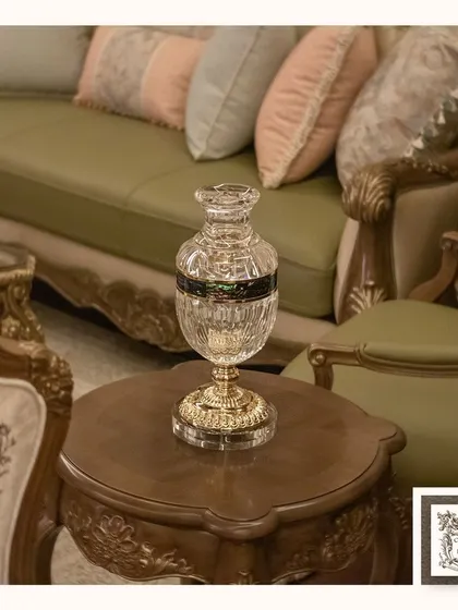 This exquisite cut-glass vase with golden accents adds a touch of royal charm to this carved wooden side table. It's a perfect vessel for a small bouquet or can stand alone as a decorative object.