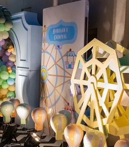 Inside the carnival, a ferris wheel prop and hot air balloon lights add to the whimsical and fun atmosphere.