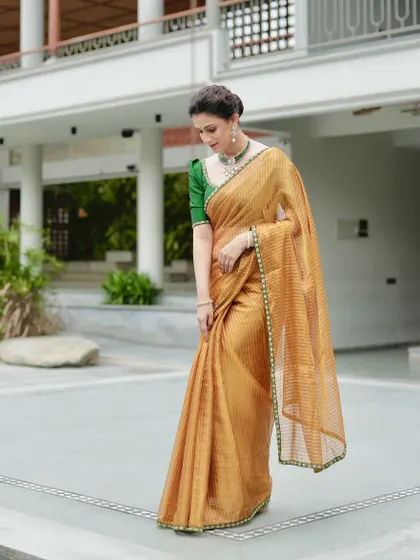 Another angle of the golden tissue silk saree, perfect for weddings or upscale cultural events.