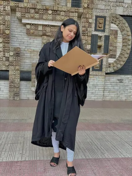 Reviewing a case file outside the Delhi High Court. Thorough preparation is key, and I make sure to be fully prepared before every hearing to best represent your interests.