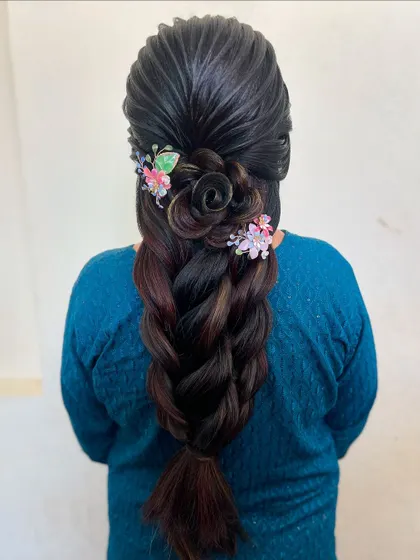Another example of a hair rose braid, this time with colorful, whimsical butterfly clips. This style is playful yet intricate, showcasing advanced techniques.