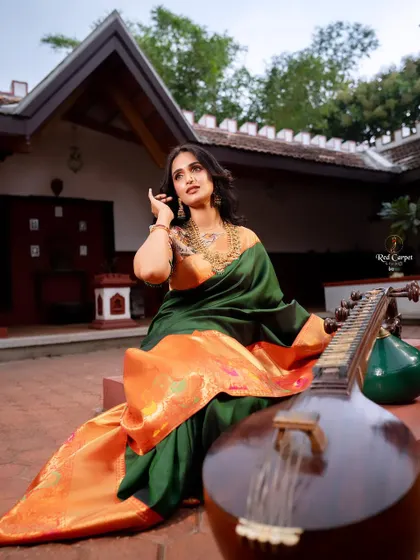 Actress Kaavya Shastry looking stunning in a dark green silk saree with a vibrant orange border for Day 6 of 'Navataara'.