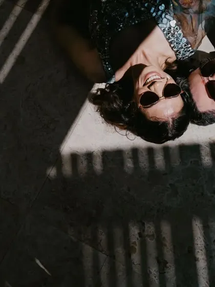 An artistic overhead shot of the couple relaxing in the shadows after their vibrant haldi celebration.