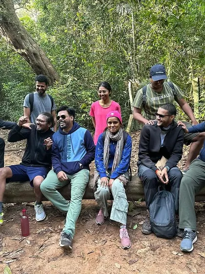 A happy and relaxed group takes a break on a fallen log during their Agumbe jungle trek. These are the moments of connection I strive to create.