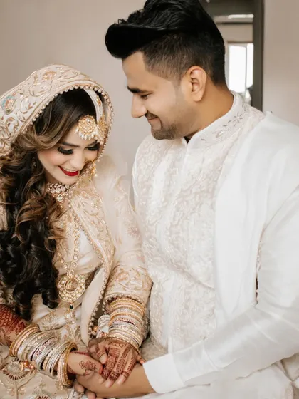 A tender moment between the bride and groom during their Nikah ceremony, their hands clasped together, heads bowed in prayer.