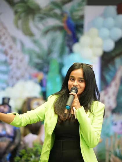 In my element with a mic in hand at a jungle-themed birthday party. I love tailoring the event to the theme and making sure the kids and adults are all entertained.