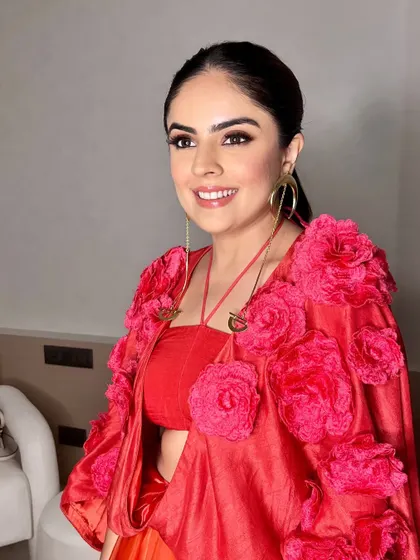 A smiling shot of this fun and fashionable look. The makeup is chic and modern, perfect for a stylish engagement party.