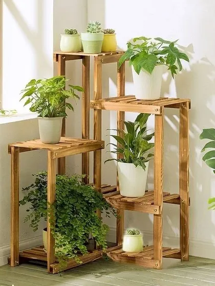 An example of how our corner planter stand can help you create a lush green corner inside your home, holding a variety of houseplants from ferns to succulents.