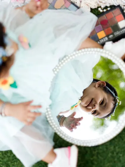 An overhead view of our little model and her reflection. This perspective captures the whole setup and her adorable expression.