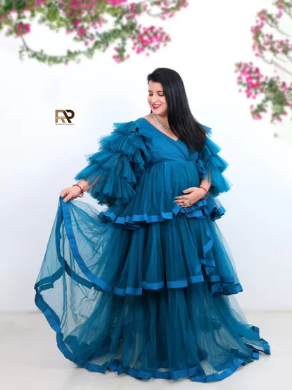 A playful twirl in a gorgeous blue gown. This shot captures the movement and flow of the dress, adding a dynamic and joyful element to the portrait.