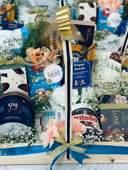 The combination of fresh flowers, premium snacks, and elegant packaging makes this hamper a standout gift.