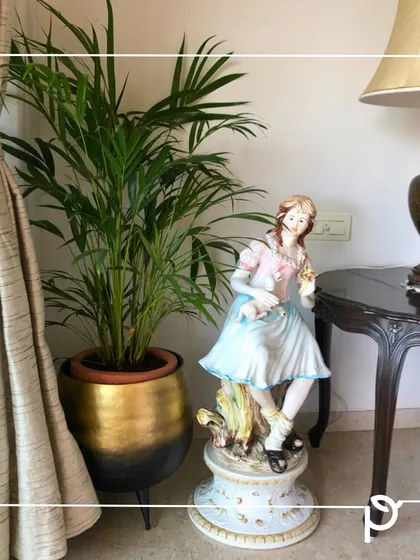 An Areca Palm in a stylish two-toned planter adds a touch of green to this classic interior. We help clients select the right plant and pot to complement their handpicked decor items.